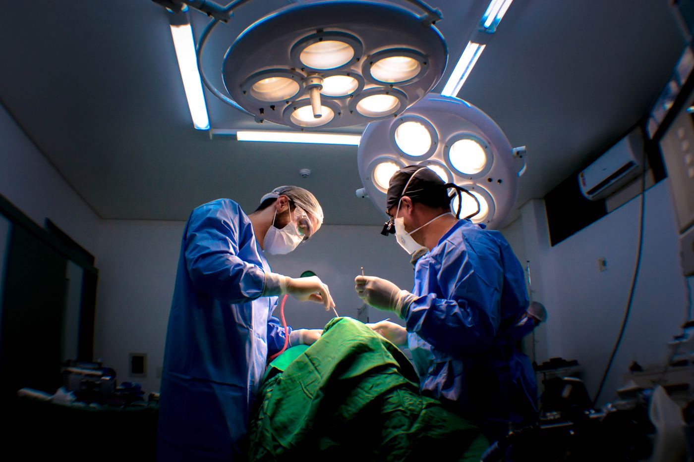 Surgeons at work under theatre lights